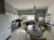 Grey and white eat-in kitchen features retro light fixture and tiled floors at 218 S 5Th Ave, Beech Grove, IN 46107