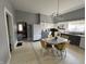 Grey and white eat-in kitchen with tiled floors and retro light fixture at 218 S 5Th Ave, Beech Grove, IN 46107