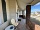 Charming covered front porch featuring brick pillars and a cozy seating area overlooking the street at 218 S 5Th Ave, Beech Grove, IN 46107