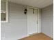 Close-up of the white front door with traditional hardware and a stylish outdoor light fixture at 2230 Mindy Ct, Anderson, IN 46017