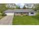 Charming single story home featuring a gray roof, welcoming front porch, and well-manicured lawn at 2230 Mindy Ct, Anderson, IN 46017