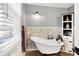 Relaxing bathroom featuring a standalone tub, white brick accents, and unique nautical decor, creating a serene retreat at 265 Goodnight Rd, Martinsville, IN 46151