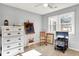 Bright bedroom featuring a ceiling fan, a sun-filled window, and a decorative dresser with a unique display at 265 Goodnight Rd, Martinsville, IN 46151