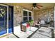 Relaxing covered front porch with stone accents, a ceiling fan, and comfortable seating area, creating a cozy outdoor space at 265 Goodnight Rd, Martinsville, IN 46151