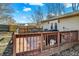 A wooden deck is accented with a grill, chairs, and lush green trees at 265 Goodnight Rd, Martinsville, IN 46151