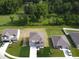 Aerial view of gray two-story home surrounded by green lawns and mature trees at 3328 Stafford St, Sheridan, IN 46069
