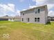 The backyard features green grass with a gray siding home and an exit door at 3328 Stafford St, Sheridan, IN 46069