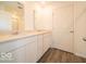 This bathroom features a double vanity, granite countertops, and wood-look flooring at 3328 Stafford St, Sheridan, IN 46069