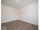 Bedroom featuring stylish gray laminate flooring, white walls, and natural light at 3328 Stafford St, Sheridan, IN 46069