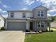 Charming two-story home with a well-manicured lawn, a two car garage and appealing architectural details at 3328 Stafford St, Sheridan, IN 46069