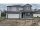 New two-story home with gray siding, a two-car garage, and classic architectural details at 3328 Stafford St, Sheridan, IN 46069