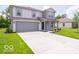 Charming two-story home with gray siding, a well-manicured lawn, and an attached two-car garage at 3328 Stafford St, Sheridan, IN 46069