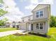 Charming two-story home with gray siding, a well-manicured lawn, landscaping, and attached two-car garage at 3328 Stafford St, Sheridan, IN 46069