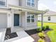 View of the covered front porch with gray columns, landscaping, and a dark blue front door at 3328 Stafford St, Sheridan, IN 46069