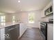 The kitchen has an island with a sink and stainless steel appliances at 3328 Stafford St, Sheridan, IN 46069