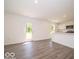 Open-concept living area with door, light gray floors, and white walls at 3328 Stafford St, Sheridan, IN 46069