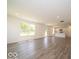 Spacious open-concept living room with lots of light, modern flooring, white walls, and a view into the kitchen at 3328 Stafford St, Sheridan, IN 46069