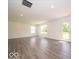 Open-concept living space with modern flooring, a rear entrance, and white walls at 3328 Stafford St, Sheridan, IN 46069