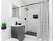 Modern bathroom with marbled tile shower, sleek vanity, and matte black fixtures for an elegant touch at 3750 Totem Ln, Indianapolis, IN 46208