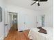 Bedroom featuring hardwood floors, neutral walls, a ceiling fan, and access to other parts of the home at 3750 Totem Ln, Indianapolis, IN 46208