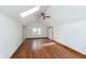 Bright bedroom features hardwood floors, a window, skylight and white walls, creating an open and airy space at 3750 Totem Ln, Indianapolis, IN 46208