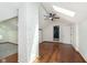 This bedroom features a skylight, ceiling fan, wood floors, painted brick column, and white walls at 3750 Totem Ln, Indianapolis, IN 46208