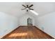 This bedroom has beautiful hardwood floors, white walls, and a skylight for natural light at 3750 Totem Ln, Indianapolis, IN 46208