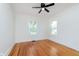 Inviting bedroom with hardwood floors, two windows providing natural light and a modern ceiling fan at 3750 Totem Ln, Indianapolis, IN 46208