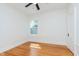 Bright bedroom featuring hardwood floors, a ceiling fan, and a window letting in natural light at 3750 Totem Ln, Indianapolis, IN 46208