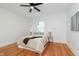 Charming bedroom boasts hardwood floors, neutral walls, a ceiling fan, and a comfortable queen-size bed at 3750 Totem Ln, Indianapolis, IN 46208