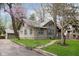 Charming two-story home with a well-maintained lawn, landscaped yard, and quaint walkway to the front door at 3750 Totem Ln, Indianapolis, IN 46208