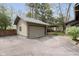A single-car garage with a green trim and siding, offering convenient parking and additional storage space at 3750 Totem Ln, Indianapolis, IN 46208