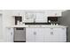 Modern kitchen with sleek white cabinets, stainless steel appliances, and stylish backsplash at 3750 Totem Ln, Indianapolis, IN 46208