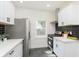 Modern kitchen featuring stainless steel appliances, stylish subway tile, and an open layout at 3750 Totem Ln, Indianapolis, IN 46208