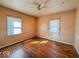 Bedroom featuring hardwood floors, two windows, and neutral-colored walls at 3751 N Sadlier Dr, Indianapolis, IN 46226