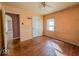 This bedroom features a ceiling fan, wood floors and a window at 3751 N Sadlier Dr, Indianapolis, IN 46226