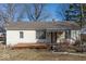Cozy single story home featuring a covered front porch with ample windows for natural light at 3751 N Sadlier Dr, Indianapolis, IN 46226