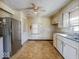 Kitchen with stainless steel refrigerator, laminate flooring, and white cabinets at 3751 N Sadlier Dr, Indianapolis, IN 46226