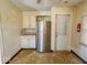 Kitchen featuring stainless steel refrigerator, laminate flooring, and white cabinets at 3751 N Sadlier Dr, Indianapolis, IN 46226