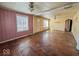 Bright living room with hardwood floors, large windows, and neutral-colored walls at 3751 N Sadlier Dr, Indianapolis, IN 46226