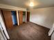 Spacious bedroom with neutral carpeting and three closets for storage at 424 Wayside Dr, Plainfield, IN 46168