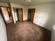 Simple bedroom featuring neutral carpet, adequate lighting, and closet space at 424 Wayside Dr, Plainfield, IN 46168