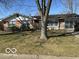 Well-maintained single-story home with a lush green lawn and mature trees at 424 Wayside Dr, Plainfield, IN 46168