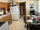 Kitchen with a full-size refrigerator and dining area; ample space for meal prep at 424 Wayside Dr, Plainfield, IN 46168