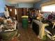 Cluttered living room space with blue walls, brick floor, and storage cabinets at 424 Wayside Dr, Plainfield, IN 46168