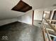 Unfinished attic space with exposed rafters and natural light, offering potential for customization at 4534 N State Road 9, Anderson, IN 46012