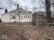 Back exterior of home featuring a brick chimney and deck at 4534 N State Road 9, Anderson, IN 46012