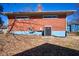 Exterior showcasing the brick facade and convenient utilities, nestled in a leaf-covered yard at 493 N Avon Ave, Avon, IN 46123