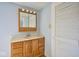 Classic bathroom vanity with oak cabinets, marble-look countertop, and mirrored medicine cabinet for storage at 493 N Avon Ave, Avon, IN 46123