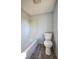 Compact bathroom with a shower-tub combo, white toilet, and wood-look vinyl flooring at 493 N Avon Ave, Avon, IN 46123